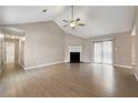 Spacious living room featuring vaulted ceiling, fireplace, fan, and sliding doors to backyard at 2065 Arbor Forest Sw Dr, Marietta, GA 30064