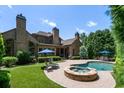 Luxury home with a pool and spa in the backyard at 830 Camden Park Ne Ct, Atlanta, GA 30342