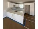 Modern kitchen featuring white cabinets and expansive island at 2435 Valient Dr, Cumming, GA 30041