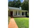 Front porch with red door and brick steps leading to the yard at 3639 Holly Springs Rd, Rockmart, GA 30153