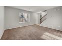 Spacious living room with neutral carpeting and large window at 620 Sheringham Ct, Roswell, GA 30076