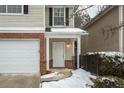 Townhome entrance with white door and snow on the ground at 646 Lakes Cir, Lithonia, GA 30058