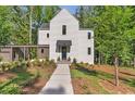 Charming two-story home with modern design and a landscaped front yard at 135 Cedarwood Ln, Roswell, GA 30075