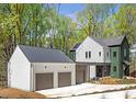 New construction featuring a two-car garage and modern farmhouse design at 135 Cedarwood Ln, Roswell, GA 30075