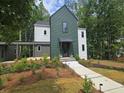 Charming two-story home featuring a lush front yard and stylish modern design at 135 Cedarwood Ln, Roswell, GA 30075