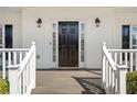 Inviting front door with sidelights and decorative lighting creating a warm entrance at 1515 Bullard Pl, Powder Springs, GA 30127