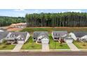 Community of new homes with wooded backdrop, showcasing contemporary design at 320 Sobeck Way, Canton, GA 30115