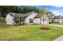 Two-story house with white siding, gray stone accents, and a lush green lawn at 320 Sobeck Way, Canton, GA 30115