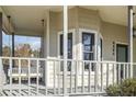 Inviting front porch with a swing and gray railing at 4485 Coventry Ne Way, Roswell, GA 30075