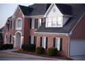 Two-story brick home showcasing a partial view of the garage at 2815 Shoemaker Ln, Snellville, GA 30039