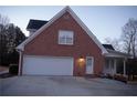 Attached two-car garage with white door and exterior side door at 2815 Shoemaker Ln, Snellville, GA 30039