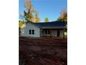 New home features a side view with a covered porch and landscaping at 30 Sportsman Path, Dallas, GA 30157