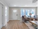 Bright living room with hardwood floors, white door, and two armchairs at 3463 Victoria St, Atlanta, GA 30337