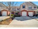 Inviting townhouse showcasing well-maintained landscaping, brick accents, and attached single-car garages at 168 Ellis Dr, Conyers, GA 30012