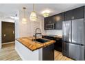 Stylish kitchen featuring dark cabinetry, herringbone countertops, and stainless steel appliances at 404 Granville Ct, Atlanta, GA 30328