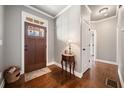 Bright entryway with hardwood floors and a wooden door at 121 Harmony Oaks Trl, Canton, GA 30115