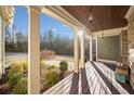 Front porch view of a wooded area, showcasing a relaxing atmosphere at 121 Harmony Oaks Trl, Canton, GA 30115