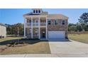 Two-story brick home with balcony, attached garage, and landscaped yard at 205 Chiswick Loop, Stockbridge, GA 30281