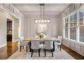 Formal dining room with hardwood floors and a modern chandelier at 5905 Kayron Dr, Atlanta, GA 30328