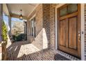 Brick entryway with a wood front door and a brick walkway at 5905 Kayron Dr, Atlanta, GA 30328