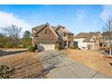 Brick house with stone accents, attached garage, and driveway at 4110 Tobiano Trl, Cumming, GA 30040