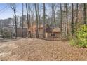 Two-story house nestled in a wooded area at 1482 Kings Ridge Dr, Norcross, GA 30093