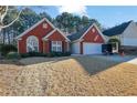 Red brick home with a well-maintained lawn at 436 Suwanee East Dr, Lawrenceville, GA 30043