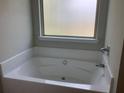 Bathroom with a large garden tub and window at 252 Magnaview Dr, Mcdonough, GA 30253