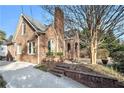 Side view of brick home showcasing driveway and landscaping at 824 Amsterdam Ne Ave, Atlanta, GA 30306