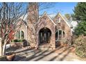 Brick home exterior with arched entryway and well-maintained landscaping at 824 Amsterdam Ne Ave, Atlanta, GA 30306