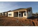 Backyard view of new construction home with multiple large windows at 2036 Ripple Park Bnd, Canton, GA 30114