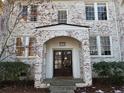 Front entrance with brick facade, arched entryway, and stone walkway at 51 Peachtree Memorial Nw Dr # 4, Atlanta, GA 30309