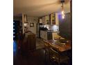 View of kitchen with stainless steel appliances, white cabinets, and a wooden dining table with chairs at 883 Verona Dr, Clarkston, GA 30021