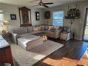 Cozy living room features a plush sectional sofa and a soft, inviting shag rug on rich, dark wood floors at 883 Verona Dr, Clarkston, GA 30021