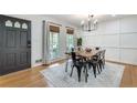 Dining area with wood table, dark chairs, and hardwood floors at 3839 Redbud Se Ct, Smyrna, GA 30082