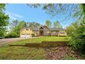 Inviting yellow house with a brick accent and a spacious yard at 4050 Old Fairburn Rd, Atlanta, GA 30349