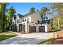 Modern farmhouse style home with white siding and two car garage at 427 Jon Scott Dr, Alpharetta, GA 30009