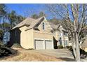 Two-story house with stone accents, shutters, and a two-car garage at 308 Hillpine Dr, Woodstock, GA 30189