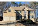 Two-story house with stone accents, shutters, and a two-car garage at 308 Hillpine Dr, Woodstock, GA 30189