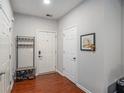 Bright entryway with wood floors, storage bench, and coat rack at 228 Ridge Mill Dr, Acworth, GA 30102