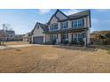 Two-story home with gray accents, landscaping, and a large yard at 5330 Austrian Pine Ct, Cumming, GA 30040