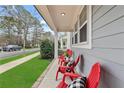 Inviting front porch with red chairs and landscaping at 164 Goshen Ln, Woodstock, GA 30188