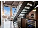 An open-concept living room with floor to ceiling windows and a glass-enclosed staircase at 170 Boulevard Se # E411, Atlanta, GA 30312