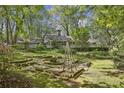 Stone patio and terraced garden in a wooded backyard setting at 4750 Rebel Trl, Atlanta, GA 30327