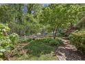 Landscaped backyard with brick walkways and lush greenery at 4750 Rebel Trl, Atlanta, GA 30327