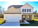 Two-story house with beige siding, stone accents, and a two-car garage at 48 Beaver Pt, Villa Rica, GA 30180