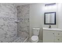 Stylish bathroom features a walk-in shower with decorative tiles, a modern vanity, and sleek fixtures at 204 Elm St, Palmetto, GA 30268