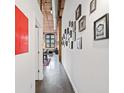 Hallway with art gallery wall leading into dining area, wood ceiling, and exposed pipes at 170 Boulevard Se # H412, Atlanta, GA 30312