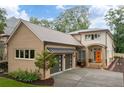 Tan brick home with modern gray garage doors and orange front door at 4225 Maner Se St, Smyrna, GA 30080