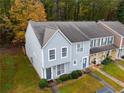 Two-story townhome with gray siding and landscaped yard at 6711 Witherington Ct, Norcross, GA 30093